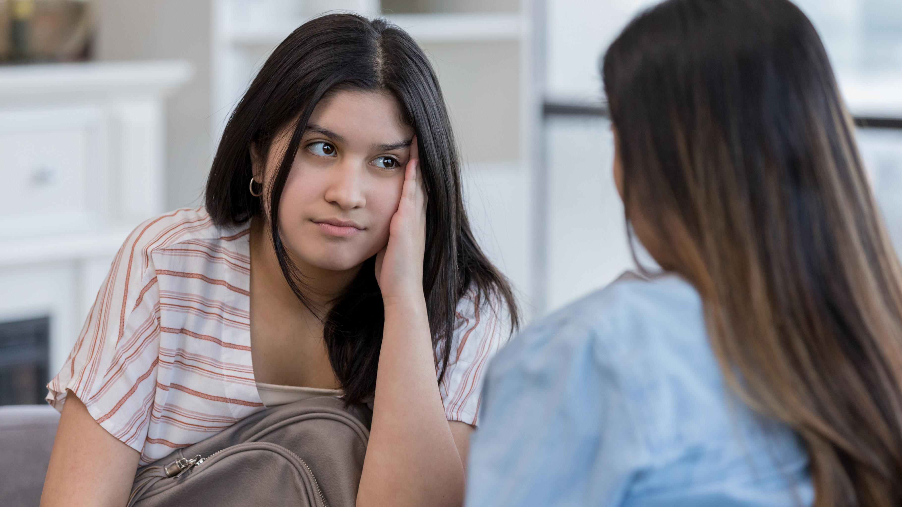 a teenage girl looking frustrated about her parents nagging her